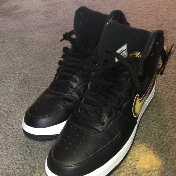 gold and black nike high tops